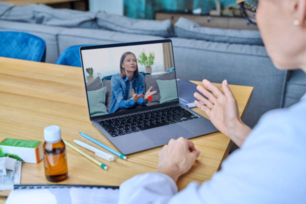 A virtual therapy session viewed on a laptop in a calm private home setting