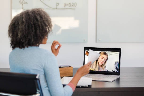 A client engaging in a private telehealth therapy session at her workspace
